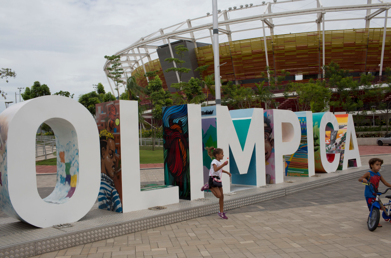 Some children use an Olympic monument as a playground (Image: AP)